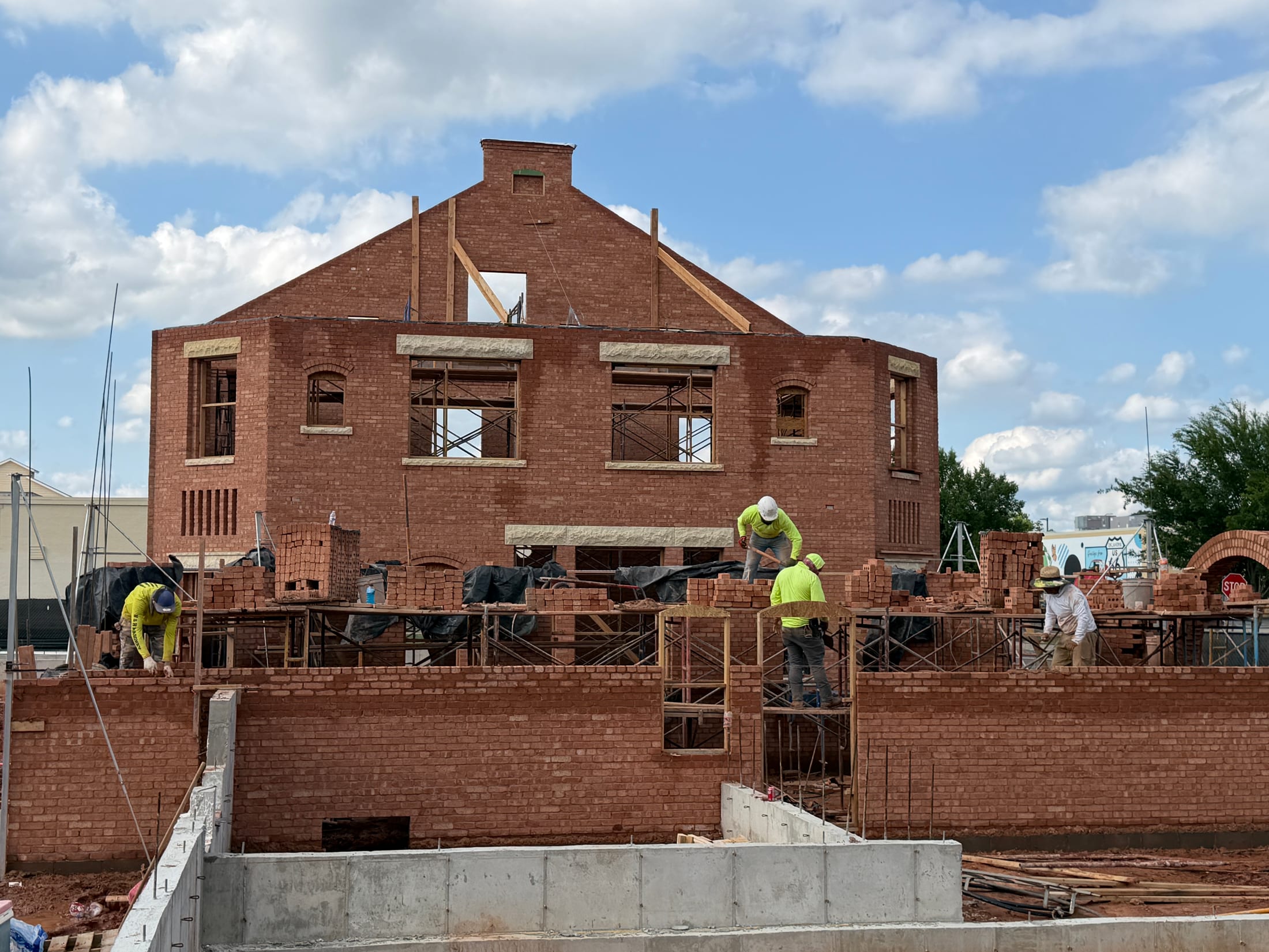 Apollo at Townsend under construction — masons laying structural brick